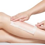 woman depilating her legs by waxing s