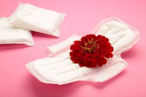 menstrual tampons pads pink background rose flower lies menstrual pad menstruation cycle hygiene protection top view vertical photo