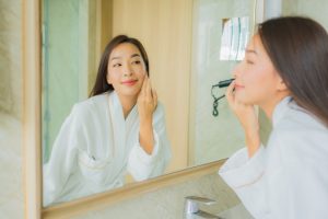 portrait beautiful young asian woman check up face bathroom