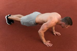 athletic man doing push ups