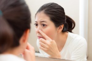 closeup photo cute pretty lady after cleaning face looking mirror checking nose having acne bathroom before going bed