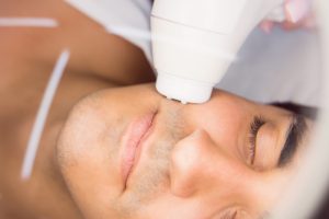 man getting facial massage clinic