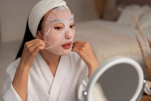 medium shot woman using face mask