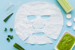 white face paper sheet with aloevera blue background