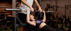 close up woman lifting bar