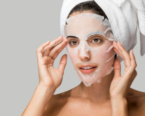 woman applying face beauty mask