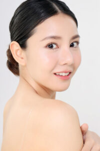 beautiful face young adult asian woman with clean fresh skin isolated white