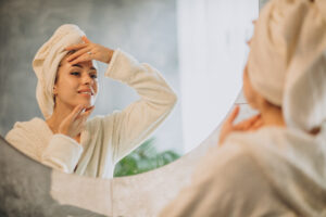 woman home applying cream mask